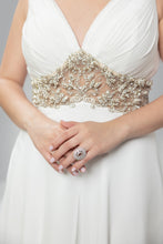 Golden Elegance: V-Neck White Gown with Gilded Waist Detail