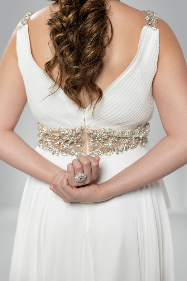Dazzling Visions: V-Neck White Gown with Golden Crystal Accents and Back Draping